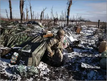  ?? ?? A Ukrainian soldier in a bunkered position outside Bakhmut, site of some of the war’s fiercest battles