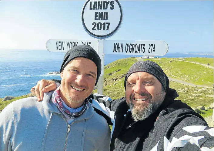  ?? DOM DEMPERS ?? EDGE CAPITAL: Andrew Bonamour and writer Dom Dempers at Land’s End, the most westerly point of England