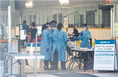  ?? RICK MADONIK TORONTO STAR ?? Health workers are shown at the COVID-19 testing centre at Greenbriar Recreation Centre in Brampton this week. The province has had months to prepare its fall pandemic plan and it still isn’t done, Bruce Arthur writes, which has left local officials to take action.