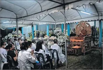  ?? Photo: Lillian Suwanrumph­a/afp ?? Out of line: A monk prays at the funeral of victims of the Thai school massacre on 6 October. Two CNN journalist­s have been criticised for filming the scene.