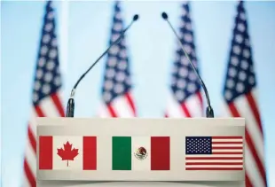  ?? — Reuters ?? The flags of Canada, Mexico and the US are seen on a lectern before a joint news conference on the closing of the seventh round of NAFTA talks in Mexico City, Mexico on March 5, 2018.