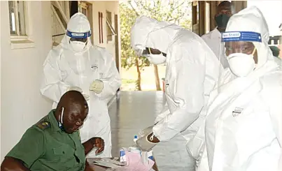  ??  ?? A Zimbabwe Prisons and Correction­al Services officer is tested for Covid-19 at Mutimurefu Prison in Masvingo recently