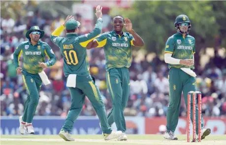  ?? — AFP ?? South Africa’s Kagiso Rabada (2R) celebrates with his team-mates after he dismissed Sri Lanka’s Shehan Jayasuriya during the first ODI at the Rangiri Dambulla Internatio­nal Cricket Stadium in Dambulla.