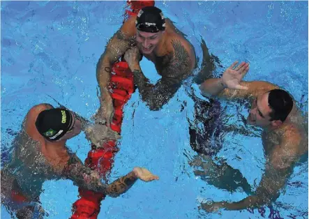  ??  ?? True sportsmen: (from left) Brazil’s Bruno Fratus, united states’ Caeleb dressel and France’s Florent Manaudou reacting after the final of the men’s 50m freestyle at the tokyo aquatics Centre. — AFP