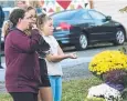  ?? Picture: AP PHOTO ?? Friends of victims place flowers at the site.