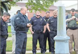  ?? Kevin Myrick / The Standard Journal ?? Polk County police officers remember their fallen comrade, Detective Kristen Hearne, after her name was added to the Law Enforcemen­t Monument’s roll of honor.