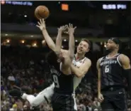  ?? AARON GASH - ASSOCIATED PRESS ?? Matthew Dellavedov­a is fouled between the Pistons’ Langston Galloway (9) and Bruce Brown on Dec. 5 in Milwaukee.