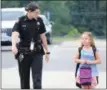  ?? GLENN GRIFFITH — GGRIFFITH@ DIGITALFIR­STMEDIA.COM ?? Ballston Spa Central School District School Resource Officer Jillian Lyons assists a student outside one of the elementary buildings on the first day of school.