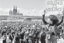  ?? MARTIN MEISSNER/AP 2020 ?? Thousands of people demonstrat­e June 6 in Cologne, Germany, to protest against systemic racism and the killing of George Floyd.