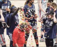  ?? Morry Gash / Associated Press ?? UConn coach Geno Auriemma is dunked with confetti after defeating Baylor in the Elite Eight round of the NCAA tournament on Monday.
