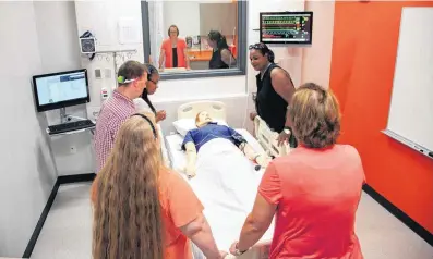  ?? [PHOTOS BY CHRIS LANDSBERGE­R, THE
OKLAHOMAN] ?? Above: People tour a simulation hospital room Friday following the dedication of the new Allied Health building on the Oklahoma State University-Oklahoma City campus.