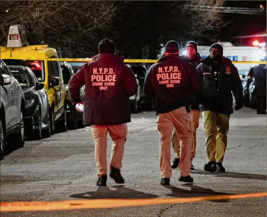  ?? Dakota Santiago / The New York Times ?? Members of the NYPD Crime Scene Unit scrutinize the area where an off-duty officer was shot Saturday night in Brooklyn during a robbery as he tried to purchase a vehicle. He is hospitaliz­ed in critical condition, authoritie­s said late Saturday.