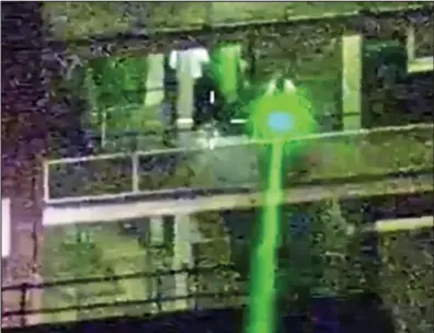  ??  ?? Dangerous: Police footage shows yobs pointing a bright green laser from a tower block in 2011