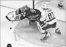  ?? [CHRIS CARLSON/THE ASSOCIATED PRESS] ?? Ducks goaltender John Gibson tries to knock the puck away from Predators center Vernon Fiddler in the first period.