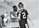  ?? AP Photo/John Bazemore ?? ■ Atlanta Falcons quarterbac­k Matt Ryan, right, speaks with wide receiver Mohamed Sanu during training camp Saturday in Flowery Branch, Ga.