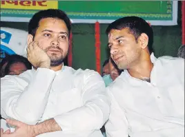  ??  ?? Bihar deputy chief minister Tejashwi Prasad Yadav (left) with his brother and health minister Tej Pratap Yadav during the 21st foundation day of RJD party at party office in Patna on July 5. PTI FILE