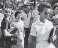  ?? WILL COUNTS/ARKANSAS DEMOCRAT-GAZETTE VIA AP, FILE ?? In this Sept. 4, 1957, photo, students of Central High School in Little Rock, Ark., including Hazel Bryan, shout insults at Elizabeth Eckford as she calmly walks toward a line of National Guardsmen.