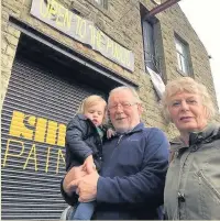  ??  ?? Greg and Linda King outside Kings Paints, Cloughfold, which is closing after 35 years, with their grandson Jude, aged one