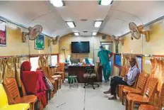  ??  ?? Patients wait for dental check-ups aboard the Lifeline Express at a railway station in Jalore.