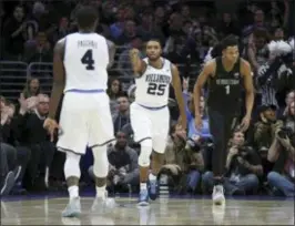  ?? CHRIS SZAGOLA — THE ASSOCIATED PRESS ?? Villanova’s Mikal Bridges, center, reacts to his 3-pointer with Eric Paschall, left, as Georgetown’s Jamorko Pickett, right, looks on during the second half. Villanova won, 97-73.