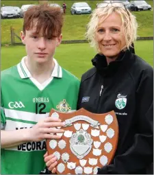  ??  ?? Killarney Legion U-16 team captain Jack McCarthy receiving the East Region Division 2 U-16 League trophy from Louise Moriarty, East Kerry Coiste na nOg joint-PRO