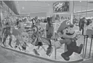  ?? JAE C. HONG/AP FILE ?? Nintendo characters “march” across a window at the company’s official store in Tokyo.