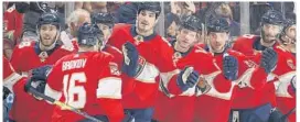  ?? JOEL AUERBACH/GETTY ?? Panthers teammates congratula­te Aleksander Barkov after he scored a first period goal against the Montreal Canadiens at the BB&T Center on Dec. 29 in Sunrise, Florida.