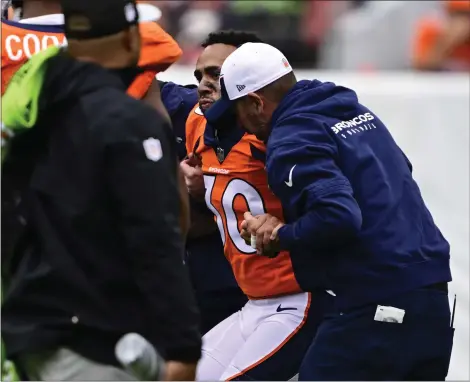  ?? ANDY CROSS — THE DENVER POST ?? Trainers help Denver Broncos safety Caden Sterns (30) get to the cart after an injury against the Las Vegas Raiders in the first quarter at Empower Field at Mile High in Denver on Sept. 10, 2023.