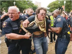  ?? JAY JANNER/AUSTIN AMERICAN-STATESMAN VIA AP ?? University of Texas police officers arrest a man Wednesday at a pro-Palestinia­n protest on campus in Austin, Texas.