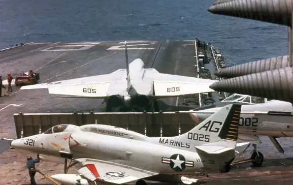  ??  ?? Above: A-4 with ordnance….A Skyhawk behind the blast barrier gets ready to take off from a carrier steaming off the Vietnam coast. (Photo by Jim Reed courtesy of Warren Thompson)