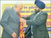  ??  ?? GNDU vicechance­llor Jaspal Singh Sandhu (right) felicitati­ng UGC chairman Virander S Chauhan in Amritsar on Friday. HT PHOTO