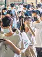  ?? AFP ?? Residents wait to undergo nucleic acid tests for Covid-19 in Guangzhou, China.