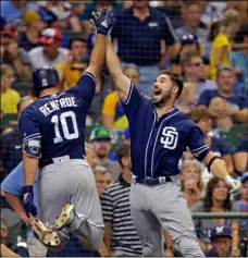  ?? AP Photo /Jefrey Phelps ?? San Diego Padres’ Hunter Renfroe (left) gets a highfive from Austin Hedges after Renfroe’s grand slam against the Milwaukee Brewers during the ninth inning of a baseball game on Thursday in Milwaukee.