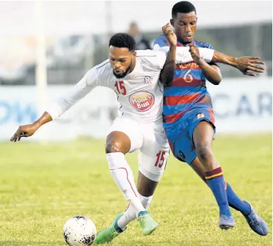  ?? FILE ?? Portmore United’s Cleon Pryce (left) comes under pressure from Junior Lumage of Arcahaie FC of Haiti during their Concacaf Caribbean Club Championsh­ip encounter at the Anthony Spaulding Sports Complex on Sunday, February 9.