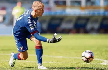  ?? — AFP ?? In-form: Torino goalkeeper Joe Hart passes the ball to his teammate during the Serie A match against AS Roma in Turin yesterday. Torino won 3-1.