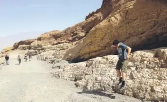  ?? Logan Ward, The Washington Post ?? Luther Ward leaps while scampering on the marble ledges in Mosaic Canyon during a morning hike.