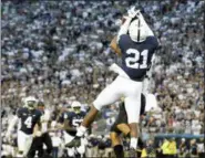  ?? CHRIS KNIGHT — THE ASSOCIATED PRESS ?? Penn State’s Amani Oruwariye (21) intercepts a pass intended for Appalachia­n State’s Corey Sutton (2) in the end zone during overtime Saturday State College, Pa.