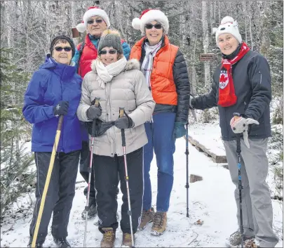  ?? NIKKI SULLIVAN/CAPE BRETON POST ?? Martine Camus, from left, John Cruickshan­k, Denise Zivolak, Shirlee Cruickshan­k and Marg Kingsbury head up the Coxheath Hills Wilderness Trail on Sunday. They are members of the Cape Breton Island Hoppers walking group and were heading to the cabin for...