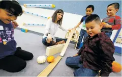  ?? LUIS SÁNCHEZ SATURNO/THE NEW MEXICAN ?? Brittany Behenna Griffith, a pre-K teacher at the Nye Early Childhood Center, plays with her students last month. Griffith is among the winners of the prestigiou­s Golden Apple Award.