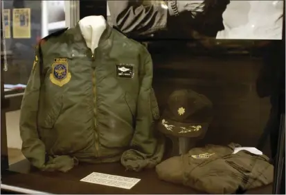  ?? CONTRIBUTE­D PHOTO, AUBREY MATTHEWS ?? Flight gear that Lt. Col. Warren wore on the Hanoi Taxi during Operation Homecoming on display at the U. S. Air Force Museum, WrightPatt­erson AFB, OH.