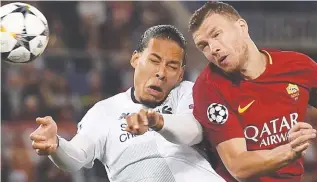  ??  ?? Liverpool defender Virgil van Dijk (left) vies with Roma striker Edin Dzeko during yesterday’s Champions League semifinal 2nd leg match at the Olympic Stadium in Rome. –