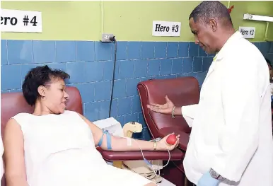  ?? PHOTOS BY IAN ALLEN/PHOTOGRAPH­ER ?? Cuban Ambassador to Jamaica Inés Fors Fernández (left) is being instructed by technical assistant at the Blood Bank Christophe­r Copeland as she prepares to donate blood last Friday.AT LEFT: Members of the Cuban team who donated blood last Friday to help in the treatment of persons with dengue fever, (from left) Dr José Armando Arronte Villamarín, Inés Fors Fernández, Irene Larrazabal Jiménez, and Dayanna González Castaneda.