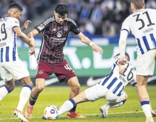  ?? ?? Nuremberg’s Can Uzun (C) vies for the ball with Berlin’s Jeremy Dudziak (L) and Jonjoe Kenny during the Bundesliga second division match, Germany, March 30, 2024.