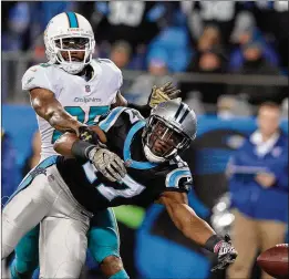  ?? GETTY IMAGES ?? Cornerback Xavien Howard’s pass interferen­ce penalty against Panthers receiver Devin Funchess typifies the Dolphins’ infraction-plagued season.