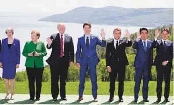  ?? Reuters ?? From left: British Prime Minister Theresa May, Merkel, Trump, Canada’s Prime Minister Justin Trudeau, Macron, Japanese Prime Minister Shinzo Abe and Italian Prime Minister Giuseppe Conte at the G7 Summit in the Charlevoix city of La Malbaie, Quebec,...