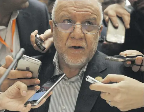  ?? RYAD KRAMDI / AFP / GETTY IMAGES ?? Iranian Oil Minister Bijan Zanganeh talks to reporters at the 15th Internatio­nal Energy Forum in Algiers. Iran is not ready to agree to an oil output freeze, he said on the eve of an informal OPEC meeting in Algeria’s capital.