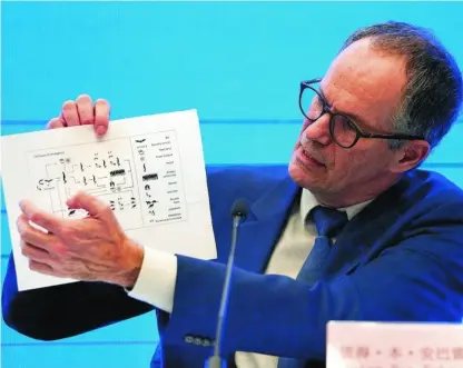  ?? AP ?? Peter Ben Embarek, miembro de la OMS, sostiene un documento con las formas de transmisió­n del virus, ayer en Wuhan