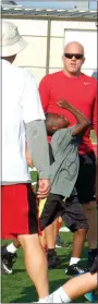  ??  ?? Young Zeph Timmons displayed the correct form as he passed by head football coach Stpehen Neal last week during Lil’ Hawk Football Camp.