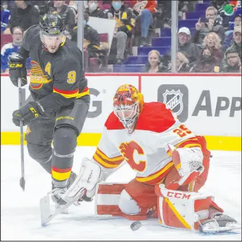  ?? Darryl Dyck The Associated Press ?? Canucks center J.T. Miller watches a rebound after a save by Flames goaltender Jacob Markstrom in the third period of Vancouver’s win Thursday at Rogers Place.