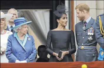  ?? Matt Dunham The Associated Press ?? Queen Elizabeth II, Meghan, the Duchess of Sussex, and Prince Harry watch as Royal Air Force aircraft in July 2018 pass over Buckingham Palace in London.